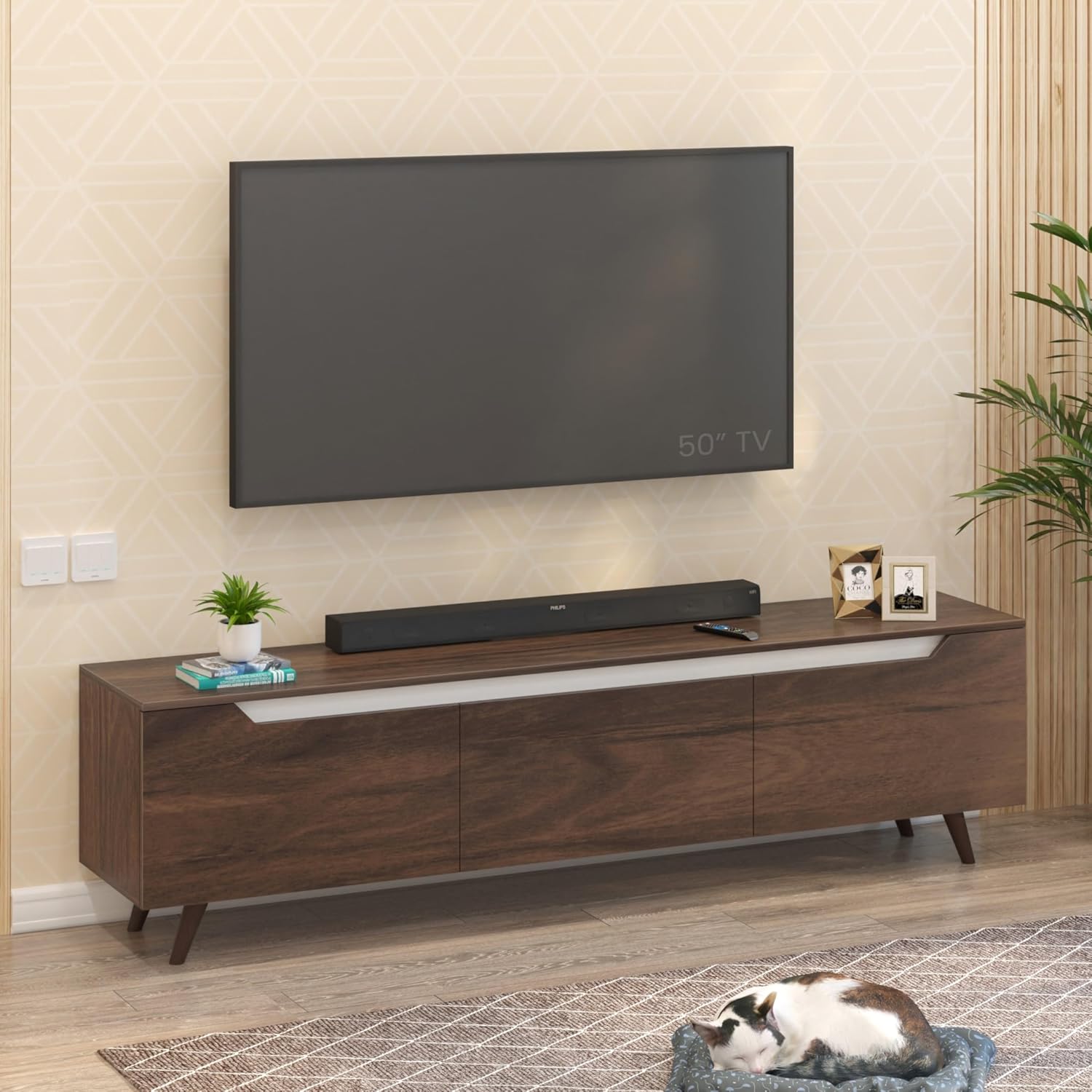 Large floor-standing walnut TV unit with three cabinet doors, angled wooden legs, and 75-inch TV compatibility, styled in a spacious modern living room